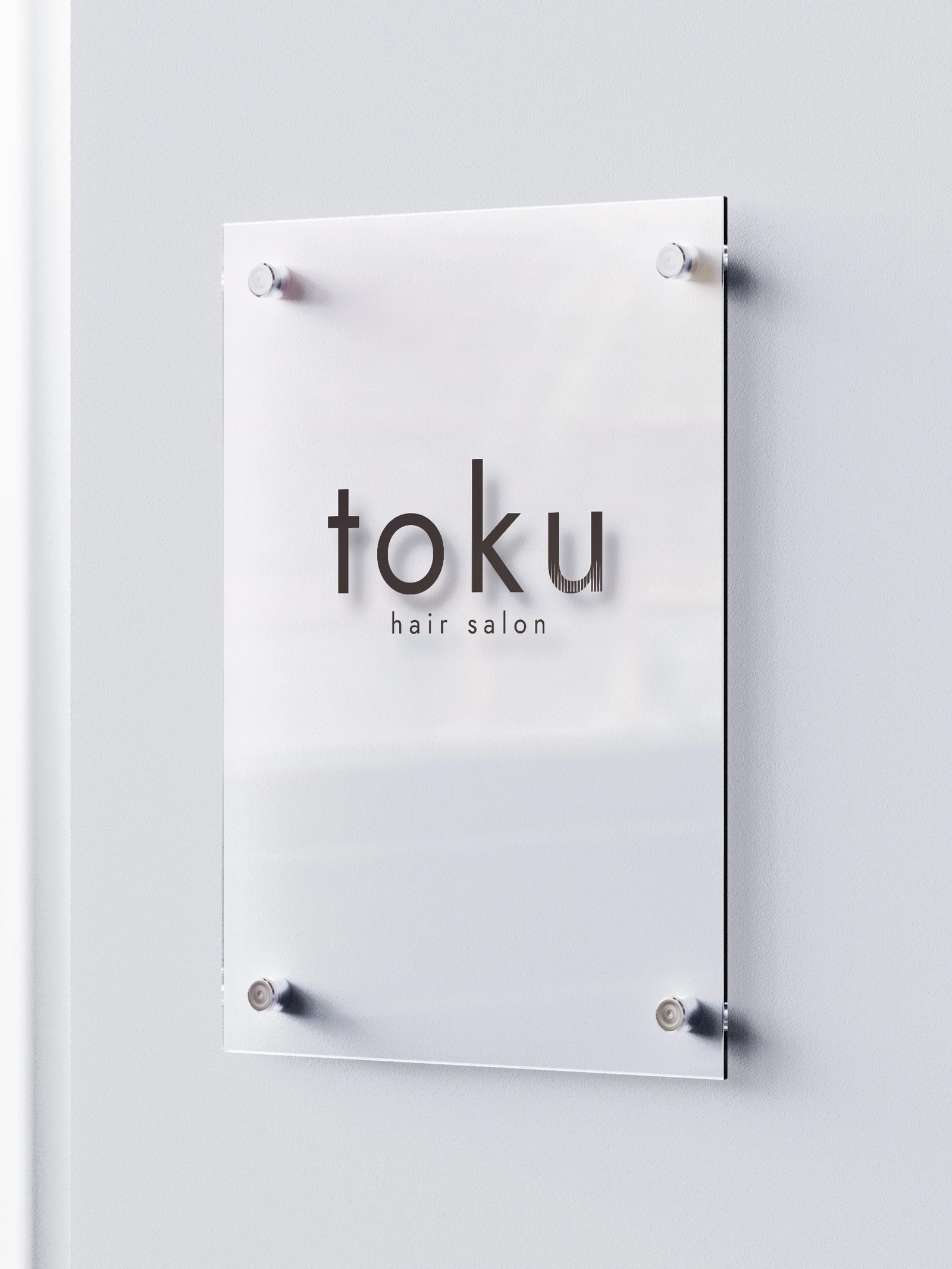 美容室tokuのロゴが透明な看板になった使用イメージ
